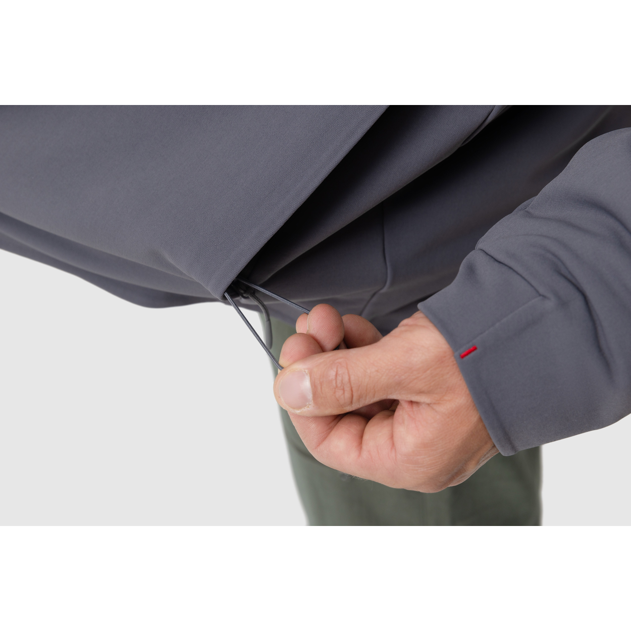 Close-up photo of the drawstring for the adjustable hem of the Tomahawk Performance Instructor Jacket.