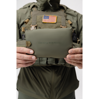 Photo of the Tomahawk Performance Crosswind Jacket, a tactical windbreaker, packed into its own integrated stow pouch in Ranger Green color way.