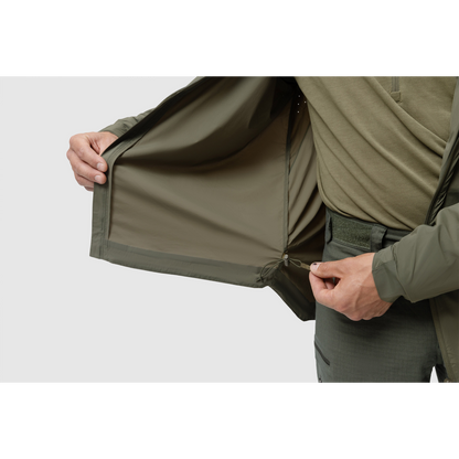Photo of the Tomahawk Performance Crosswind Jacket's interior lining around the hem including adjustable hem drawstring in Ranger Green color way. Laser perforation for ventilation also shown.