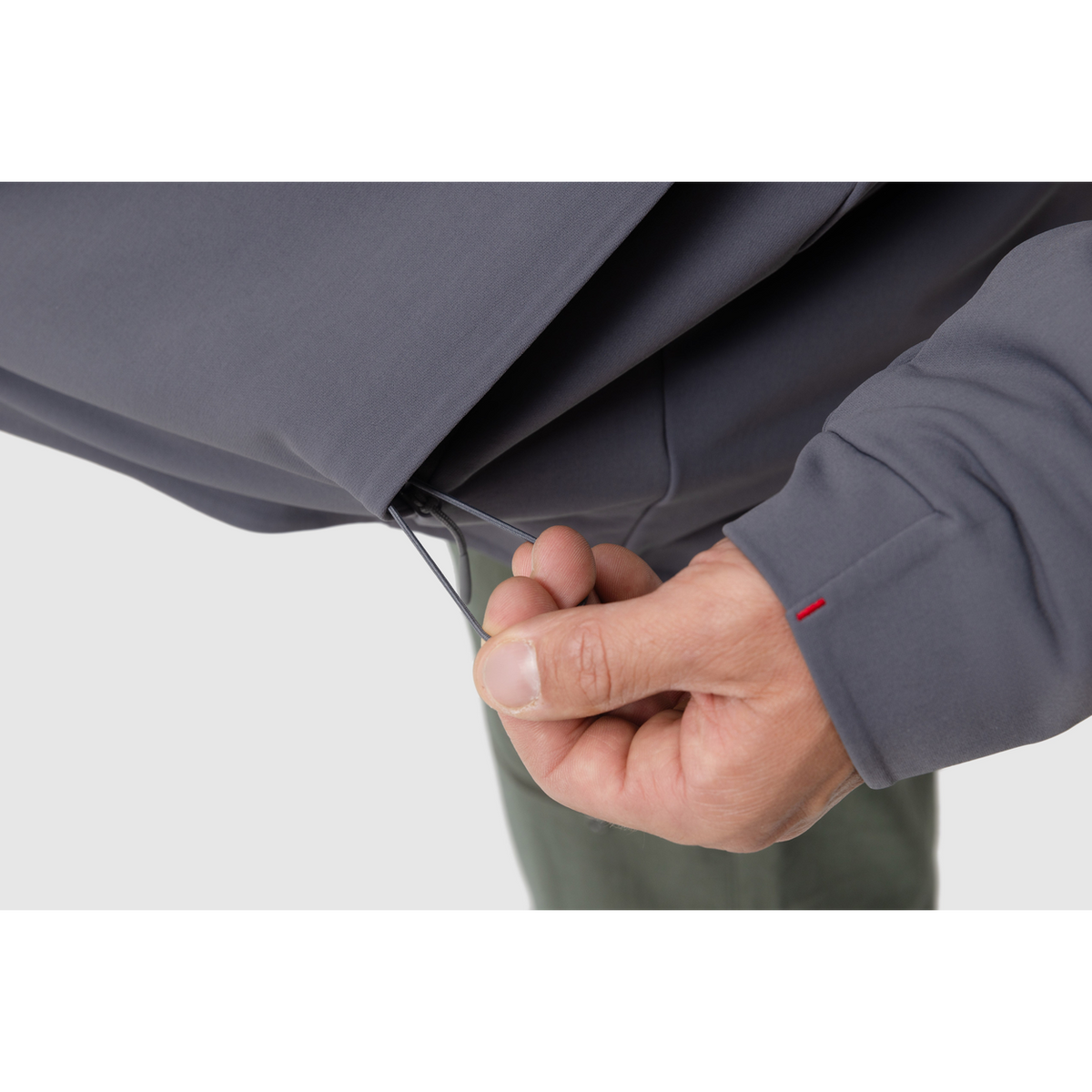 Close-up photo of the drawstring for the adjustable hem of the Tomahawk Performance Instructor Jacket.